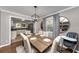 Open dining room overlooking an updated kitchen, showcasing a blend of modern design and cozy home atmosphere at 2187 Freydale Se Rd, Marietta, GA 30067