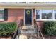 Close-up of a welcoming front entrance with a decorative wreath, stone steps, and a sturdy brick facade at 2187 Freydale Se Rd, Marietta, GA 30067