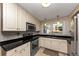 Well-lit kitchen featuring stainless steel appliances and dark countertops at 2187 Freydale Se Rd, Marietta, GA 30067