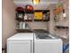 Well-organized laundry room with shelves and newer appliances at 2187 Freydale Se Rd, Marietta, GA 30067