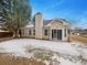 A home's backyard features a patio and a partially snow-covered lawn, with trees visible at 351 Beckenham Ln, Dacula, GA 30019