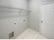 A functional laundry room with a shelf and hookups for a washer and dryer at 351 Beckenham Ln, Dacula, GA 30019