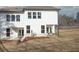 Back of house with white siding, lots of windows, and covered porch with seating at 4170 Cavalier Way, Duluth, GA 30097