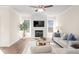 Cozy living room features a fireplace with TV, ceiling fan, and plenty of natural light at 4170 Cavalier Way, Duluth, GA 30097