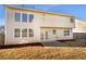 Exterior view of the home's back with large windows and a patio area at 4556 Creekside Cv, Atlanta, GA 30349