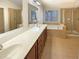 Bright bathroom featuring a double vanity, soaking tub, and a separate glass-enclosed shower at 4556 Creekside Cv, Atlanta, GA 30349