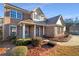 Charming two-story brick home with a well-manicured lawn and covered front porch at 4556 Creekside Cv, Atlanta, GA 30349