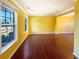 Bright living room featuring hardwood floors, large windows, and neutral walls at 4556 Creekside Cv, Atlanta, GA 30349