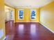 Open living room with hardwood floors and bright windows at 4556 Creekside Cv, Atlanta, GA 30349