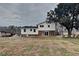 Back exterior of home with a large yard, patio door, and mature tree at 1848 Englewood Way, Snellville, GA 30078