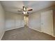 A carpeted bedroom featuring a ceiling fan, neutral paint, and a closet door at 1848 Englewood Way, Snellville, GA 30078