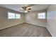 A bedroom with plush carpeting, neutral paint, and a ceiling fan with a light at 1848 Englewood Way, Snellville, GA 30078