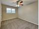 Comfortable bedroom with neutral walls, carpet flooring, and a window that provides ample natural light at 1848 Englewood Way, Snellville, GA 30078