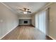 Bright living room featuring laminate flooring, a brick fireplace, and a sliding glass door for natural light at 1848 Englewood Way, Snellville, GA 30078