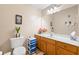 Well-lit bathroom with vanity, and toilet for a fresh, simple, and functional space at 302 Silver Summit Se Dr, Conyers, GA 30094