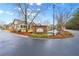 Silver Summit entrance features a brick sign, pond with fountain, landscaping and several well-maintained residential buildings at 302 Silver Summit Se Dr, Conyers, GA 30094