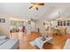 Open-concept living room featuring hardwood floors that seamlessly flow into the dining area at 302 Silver Summit Se Dr, Conyers, GA 30094