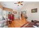 Comfortable living room featuring hardwood floors, ceiling fan, vaulted ceiling and many windows at 302 Silver Summit Se Dr, Conyers, GA 30094