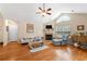 Bright living room with fireplace, ceiling fan, hardwood floors and a large window at 302 Silver Summit Se Dr, Conyers, GA 30094