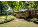 View of the deck and the backyard, with lush landscaping, patio, and playset at 4138 Hickory Dr, Powder Springs, GA 30127