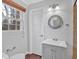 Bathroom features a window, toilet, and a vanity with white sink and modern fixtures at 4138 Hickory Dr, Powder Springs, GA 30127