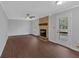 Spacious living room featuring a stone fireplace, hardwood floors, and a ceiling fan at 4138 Hickory Dr, Powder Springs, GA 30127