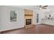 Well-lit living room featuring hardwood floors, a stone fireplace and backyard access at 4138 Hickory Dr, Powder Springs, GA 30127