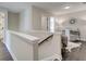 Upstairs hallway with a view into a sitting room, decorative mirror, and desk at 4537 Moray Dr, Mableton, GA 30126