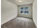 Bedroom features a large window and neutral carpeting at 6077 Oakley Rd, Union City, GA 30291