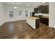 Open kitchen featuring stainless steel appliances, dark cabinets, and granite countertops at 6077 Oakley Rd, Union City, GA 30291