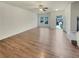 Bright living room featuring a ceiling fan, neutral walls, and wood-look flooring at 6077 Oakley Rd, Union City, GA 30291