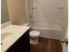 Bathroom features a toilet, sink, and shower/tub combo at 7467 Saint David St, Fairburn, GA 30213