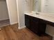 Bathroom featuring vanity with white countertop and dark wood cabinetry at 7467 Saint David St, Fairburn, GA 30213