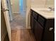 Bathroom with stylish vanity, modern fixtures, and wood-look flooring at 7467 Saint David St, Fairburn, GA 30213