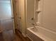 Bright bathroom showcases a shower/tub combo and updated fixtures at 7467 Saint David St, Fairburn, GA 30213