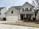 Charming two-story home featuring a classic architectural style with a two car garage at 7467 Saint David St, Fairburn, GA 30213