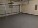 Well-lit garage with a sealed floor and access panel at 7467 Saint David St, Fairburn, GA 30213