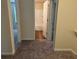 Hallway with views to a bathroom and bedroom, featuring carpet flooring at 7467 Saint David St, Fairburn, GA 30213