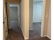 Hallway with carpeted flooring, neutral paint, and doors to bedrooms or baths at 7467 Saint David St, Fairburn, GA 30213