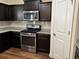 Close-up of a modern kitchen with granite countertops and stainless steel appliances at 7467 Saint David St, Fairburn, GA 30213