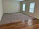 Spacious living room with carpet flooring and ample natural light from large windows at 7467 Saint David St, Fairburn, GA 30213