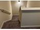 Carpeted stairs leading to upper or lower level with painted handrail at 7467 Saint David St, Fairburn, GA 30213