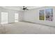 Expansive living room with a ceiling fan and natural lighting from windows showing the outdoors at 1410 Lavista Ne Rd, Atlanta, GA 30324