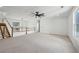 Bright living room with a modern ceiling fan, large windows, and hardwood staircase at 1410 Lavista Ne Rd, Atlanta, GA 30324