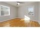 Sunny bedroom features hardwood floors, neutral walls, and ceiling fan at 1796 Arkose Se Dr, Atlanta, GA 30316