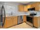 Modern kitchen featuring stainless steel appliances, tile floors, and light wood cabinets at 1796 Arkose Se Dr, Atlanta, GA 30316