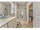 Bathroom featuring double sinks, a tile floor, and glass shower at 530 Vandenburg Dr, Villa Rica, GA 30180