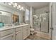 Well-lit bathroom featuring double sinks, a glass-enclosed shower, and direct access to a closet at 530 Vandenburg Dr, Villa Rica, GA 30180