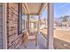 Inviting front porch featuring seating, exposed brick, and great natural light at 530 Vandenburg Dr, Villa Rica, GA 30180