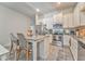 Bright open kitchen with a center island, stainless steel appliances, and barstool seating at 530 Vandenburg Dr, Villa Rica, GA 30180